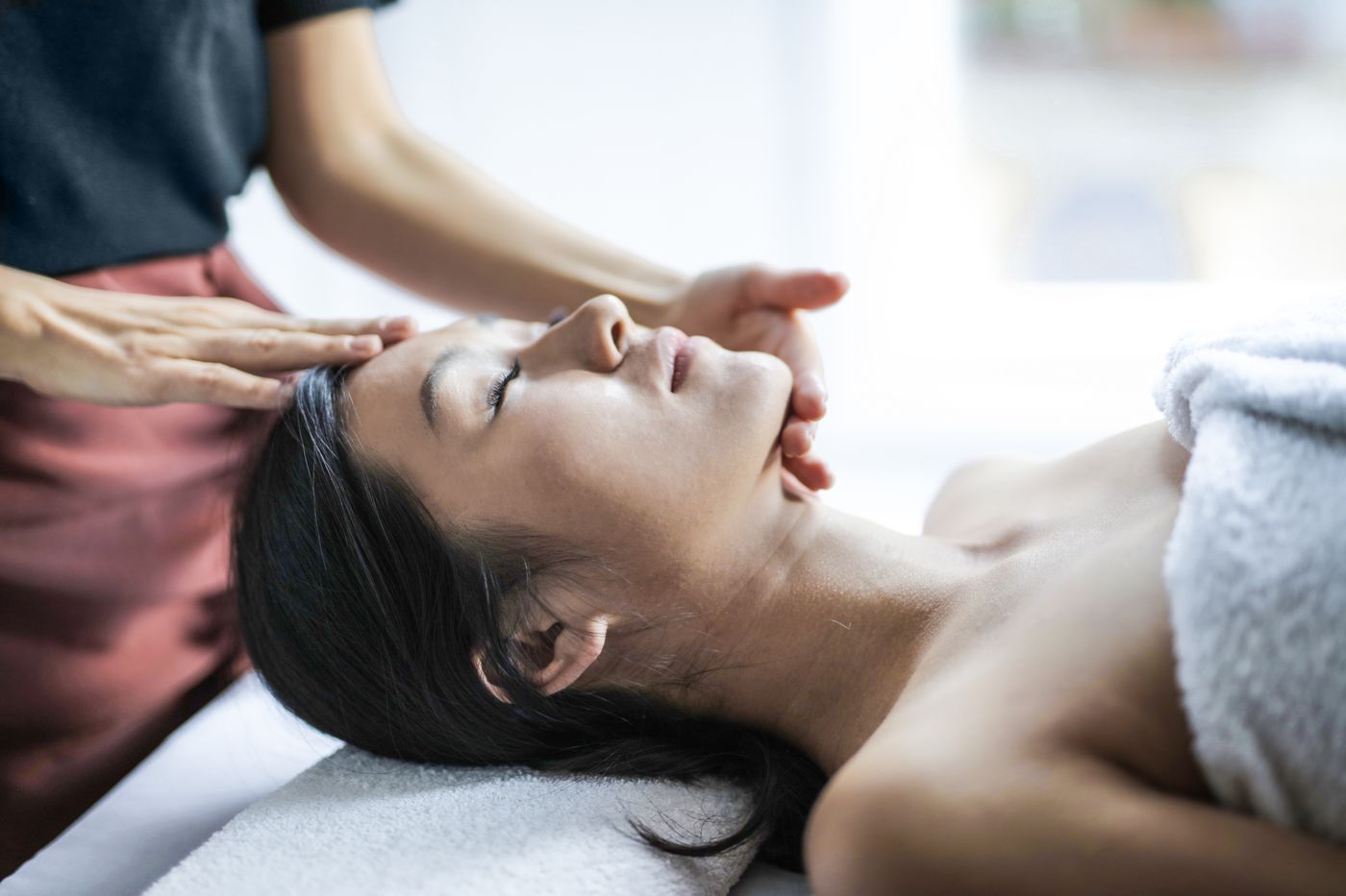Therapist giving a gentle head massage